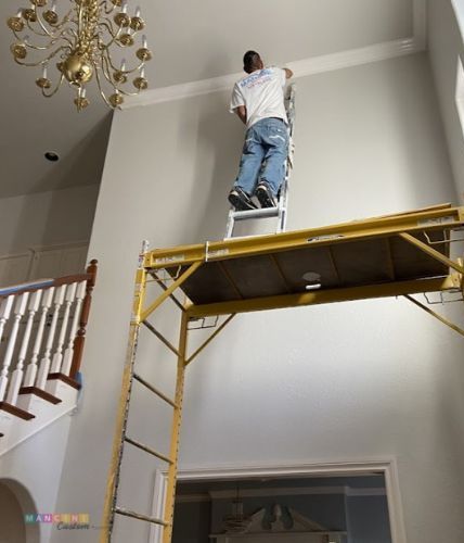 Interior painter painting a house celing