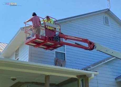 Painter working on a house exterior in Stillwater