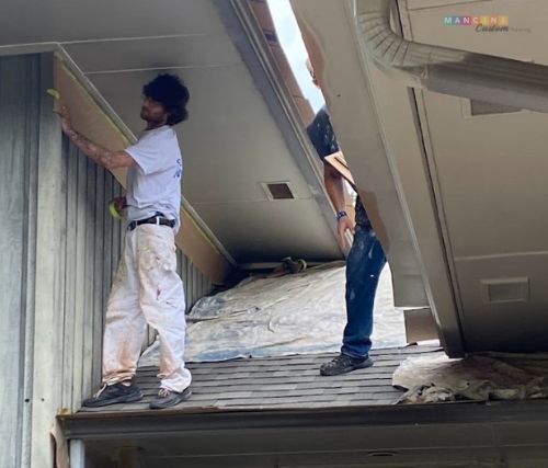 Painting contractor painting a house exterior in Stillwater