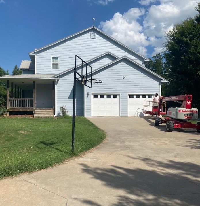 A large house with a basketball hoop in front of it