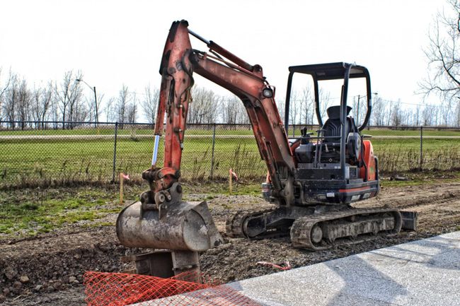 an excavation and a backhoe truck