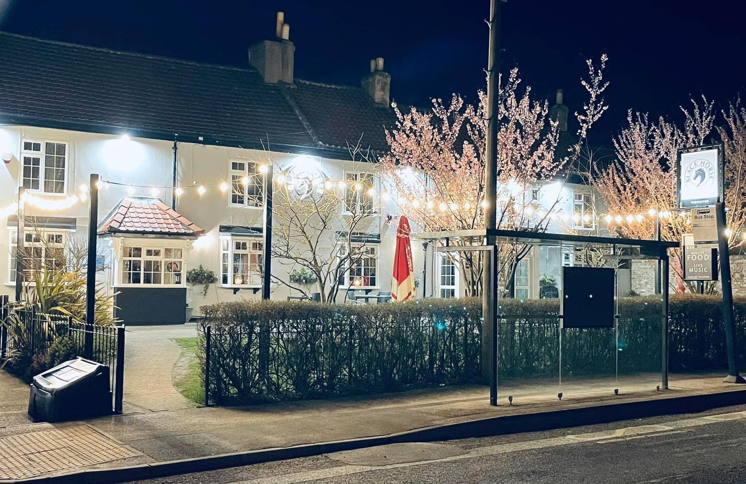 A building with a lot of lights on it is lit up at night.