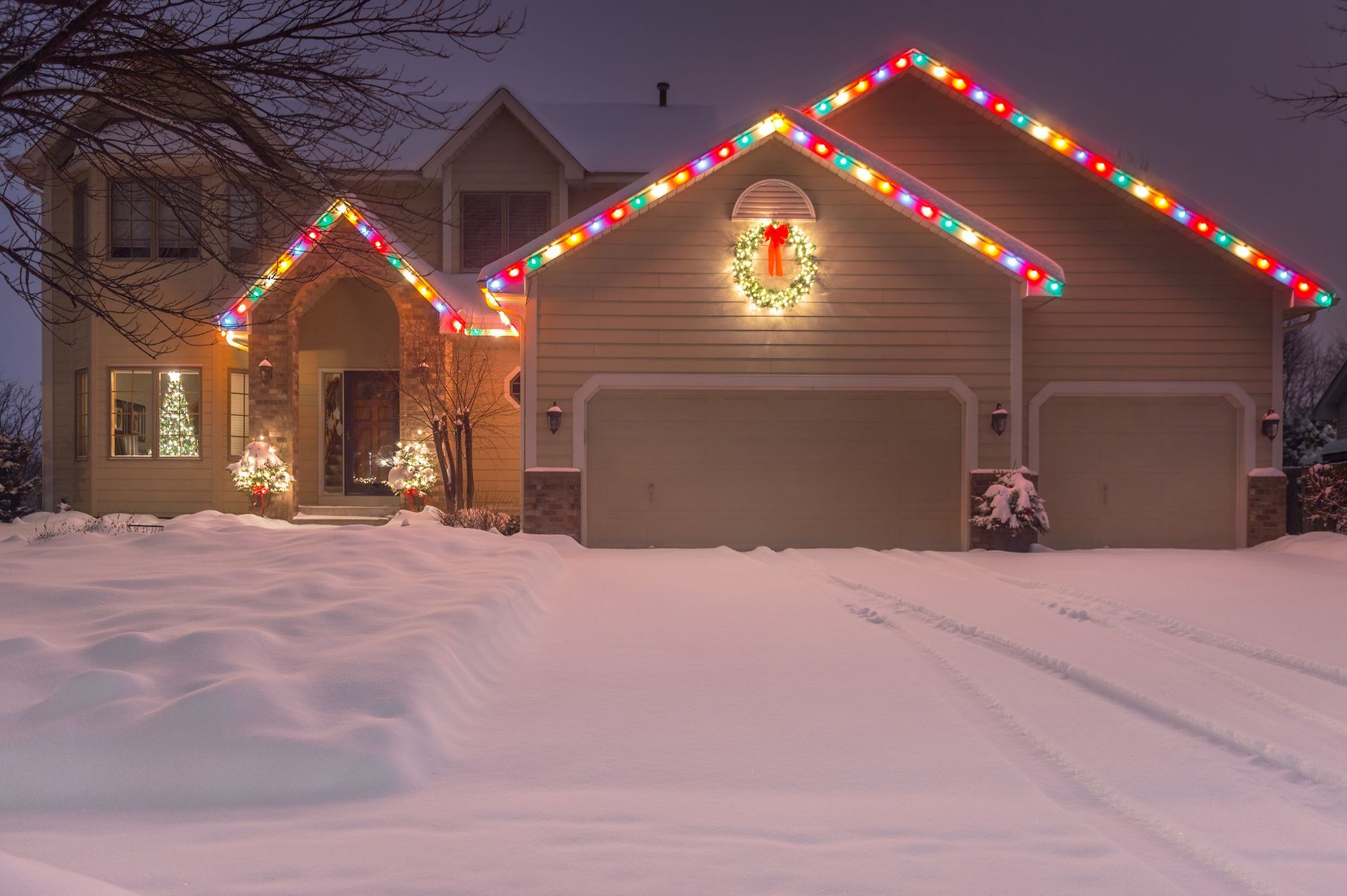 Holiday lights at night on a home in the winter