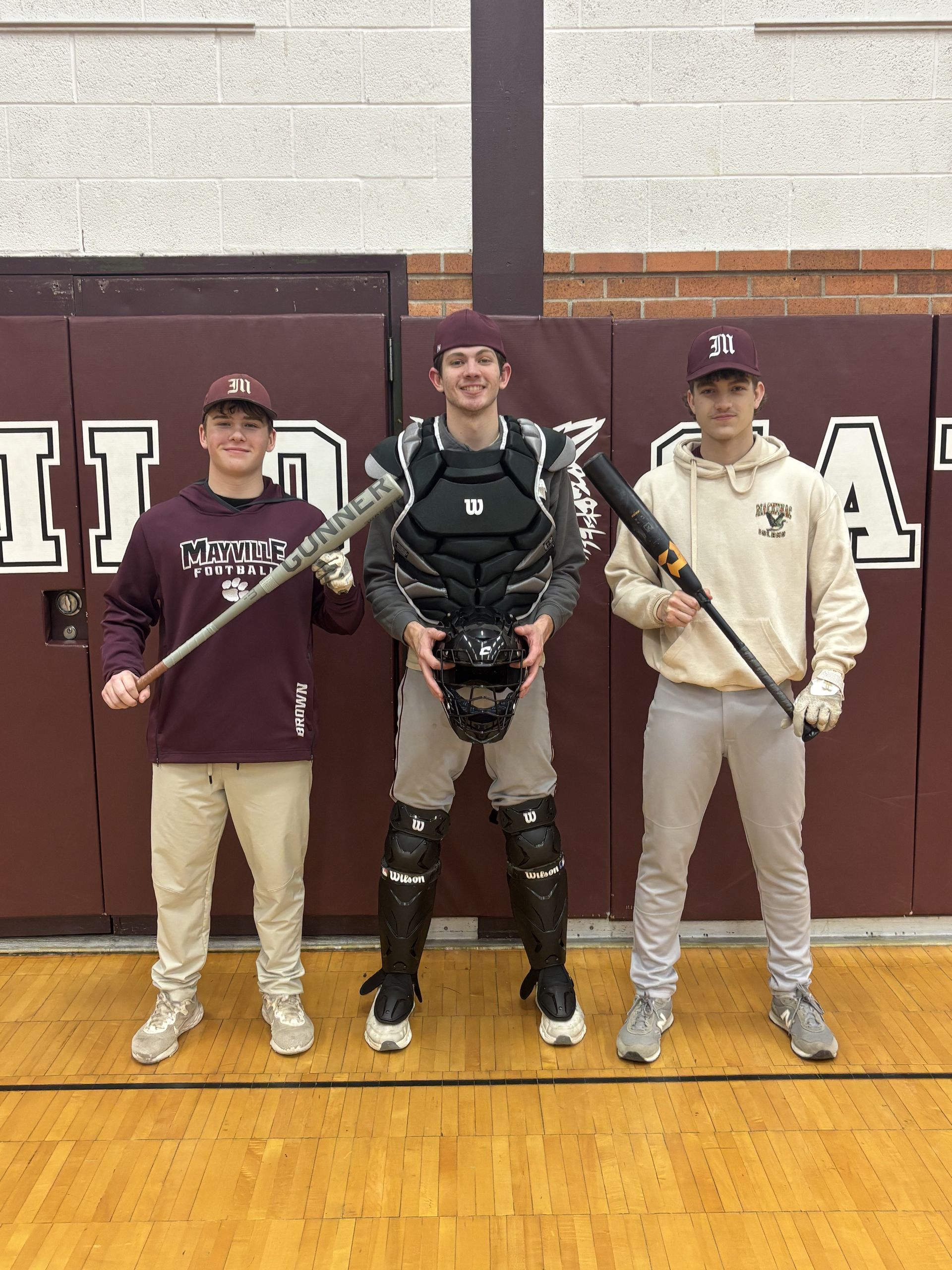3 baseball players smiling for the camera