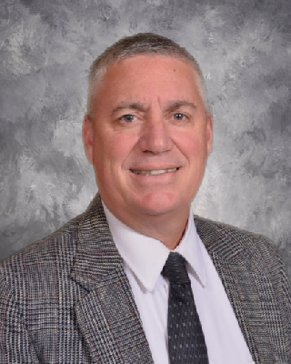 A photo of the superintendent smiling.