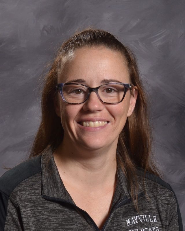 A woman wearing glasses smiles for the camera
