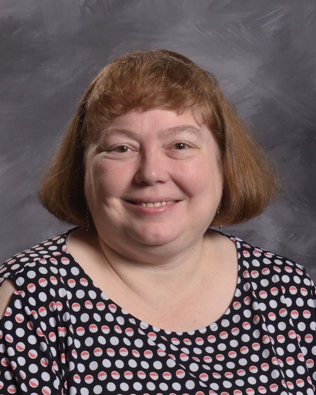 A woman smiles for the camera