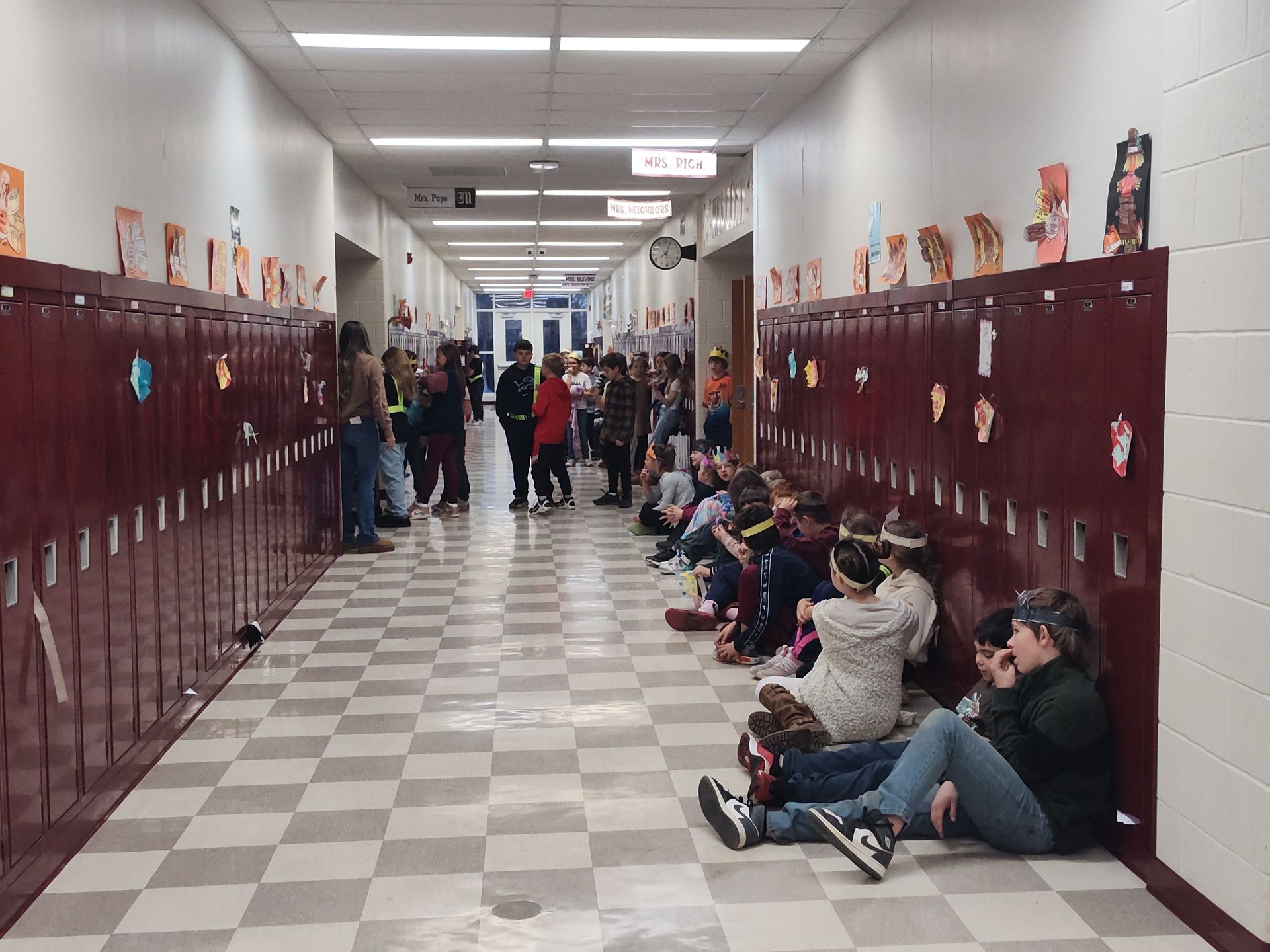 Students standing and sitting in the hallway