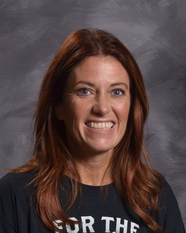 A women wearing a black sweatshirt & smiling for the camera