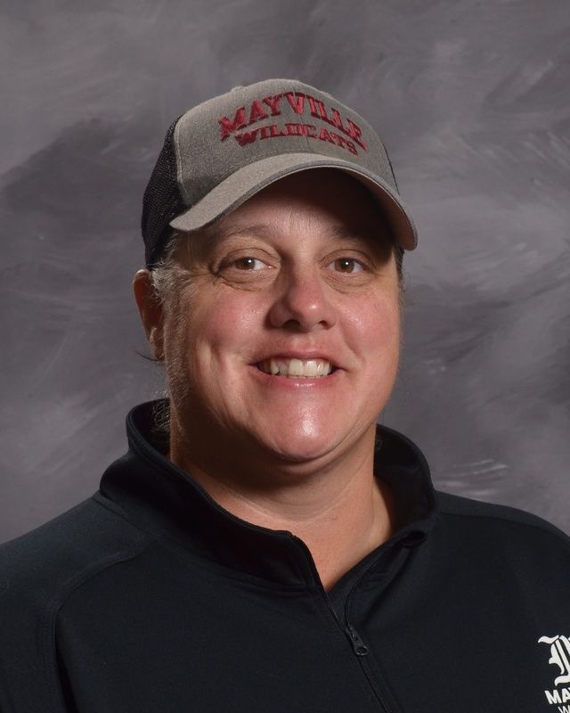 A woman wearing a hat and a black shirt smiling for the camera