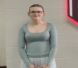 A girls in glasses smiling for the camera