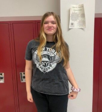 A girl with long hair smiling for the camera