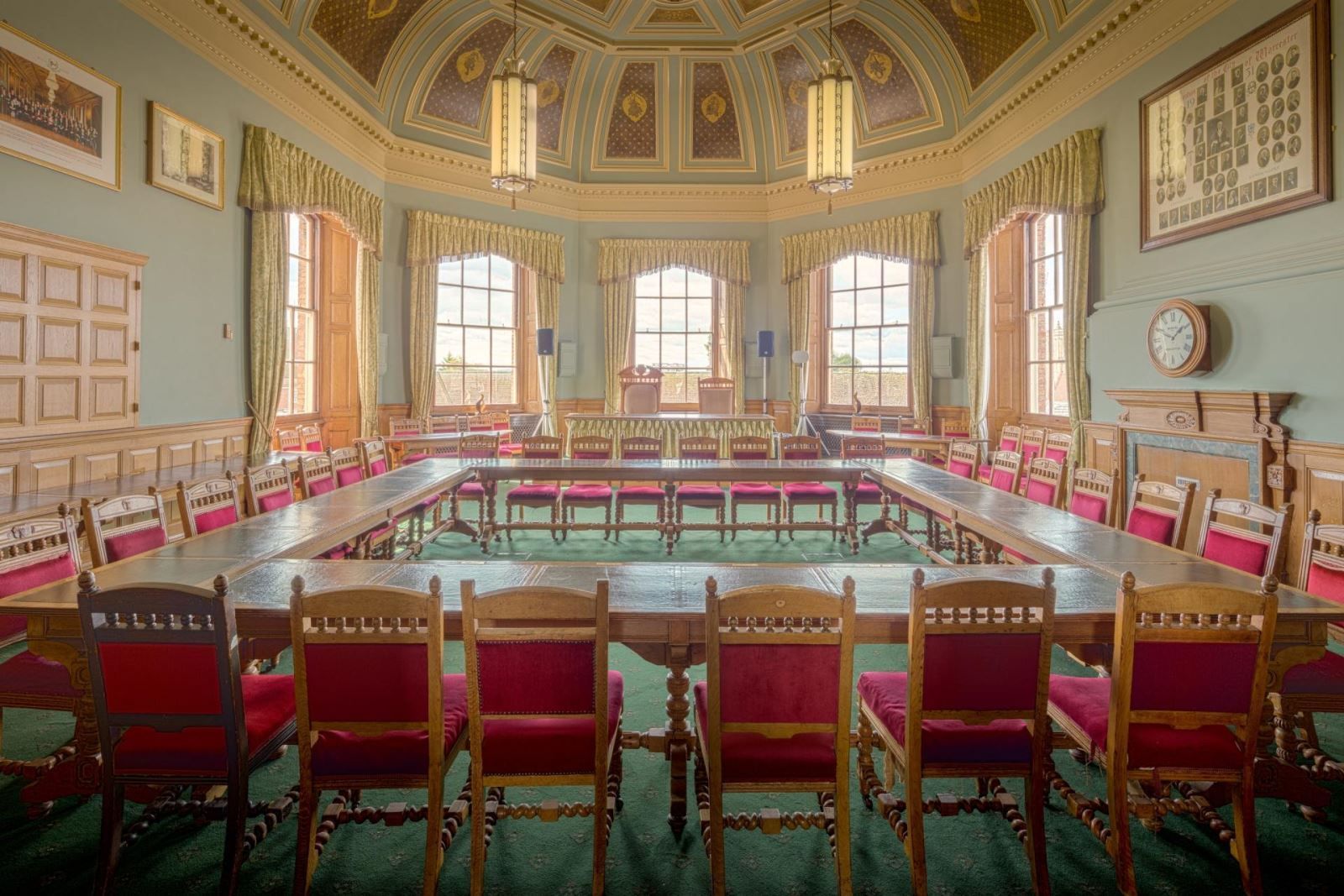 A large room with a long table and chairs in it.