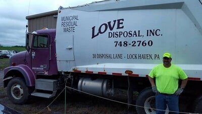 Man Standing Beside the Truck — Lock Haven, PA — Love Disposal, Inc.