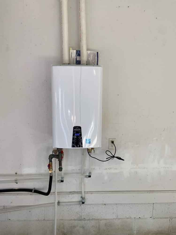 A Water Heater is Hanging on a Brick Wall in a Basement