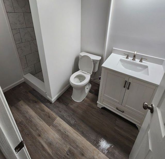 A bathroom with a toilet a sink and a shower