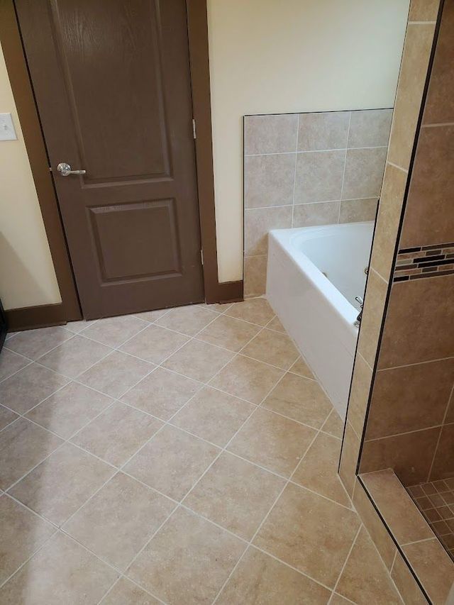 A bathroom with a bathtub and a shower.