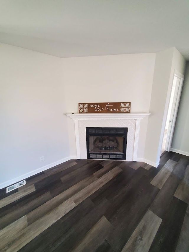 There is a fireplace in the corner of the living room.