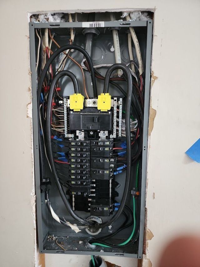 A electrical box with a lot of wires coming out of it.