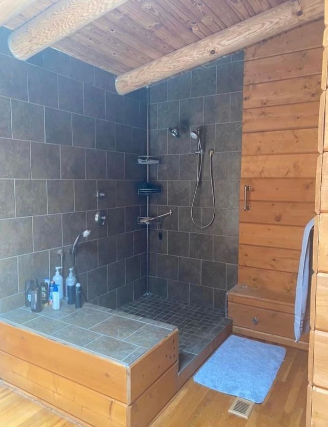 A bathroom with a walk in shower and a bathtub