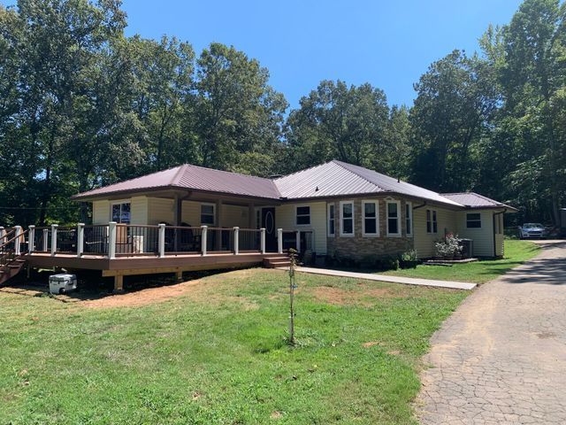 A large house with a large deck in front of it