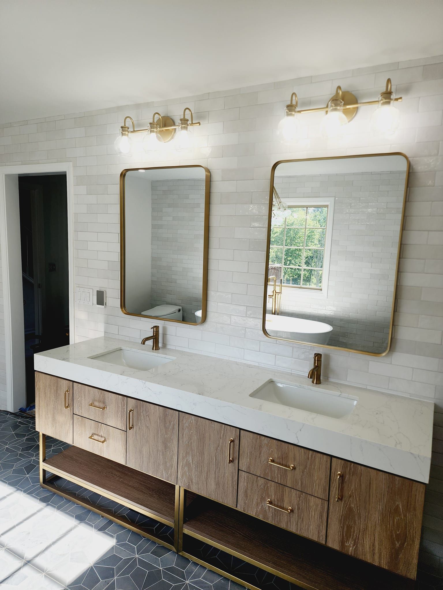 A bathroom with two sinks and two mirrors