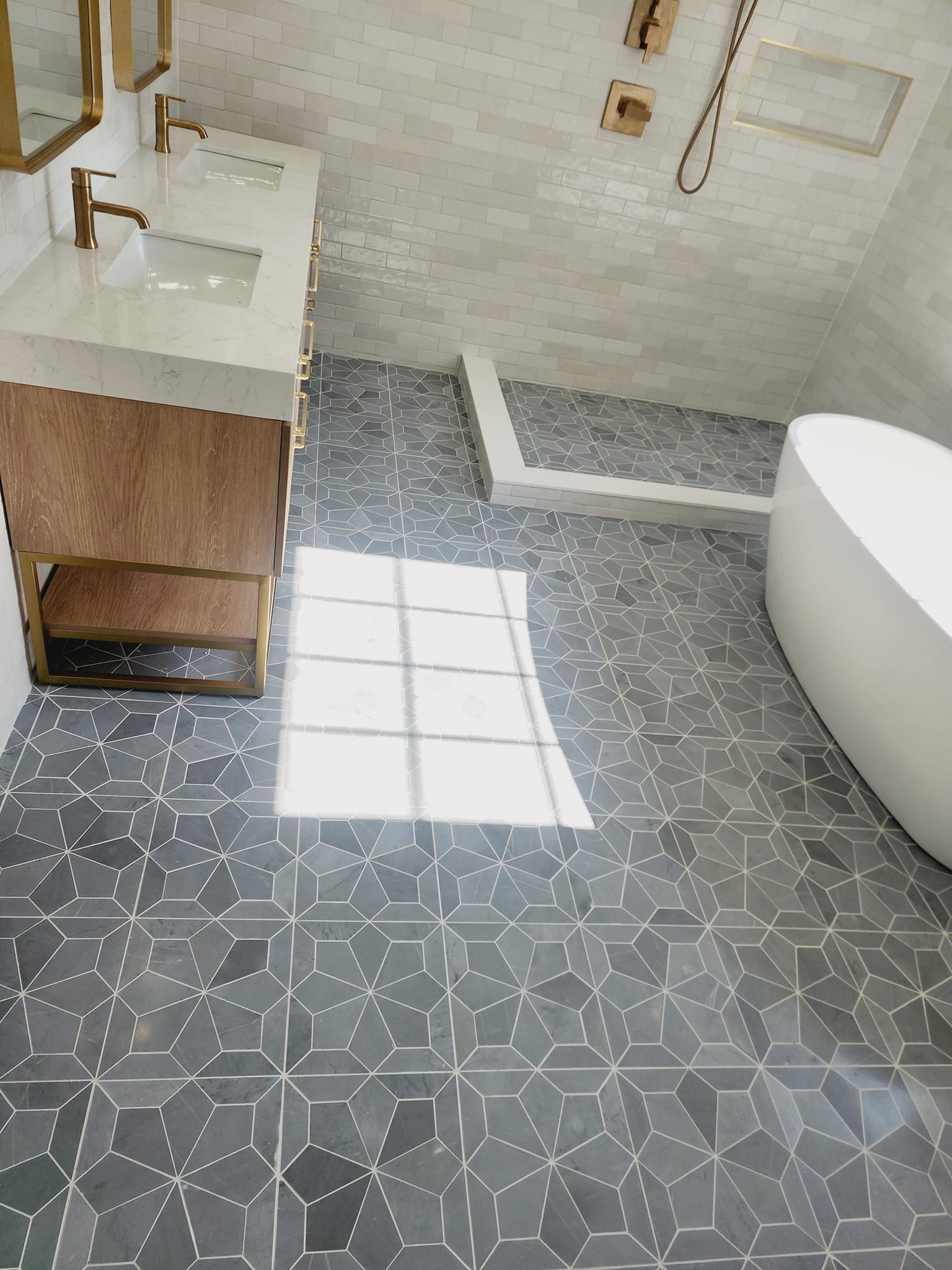 A bathroom with a tub, sink, mirror and shower