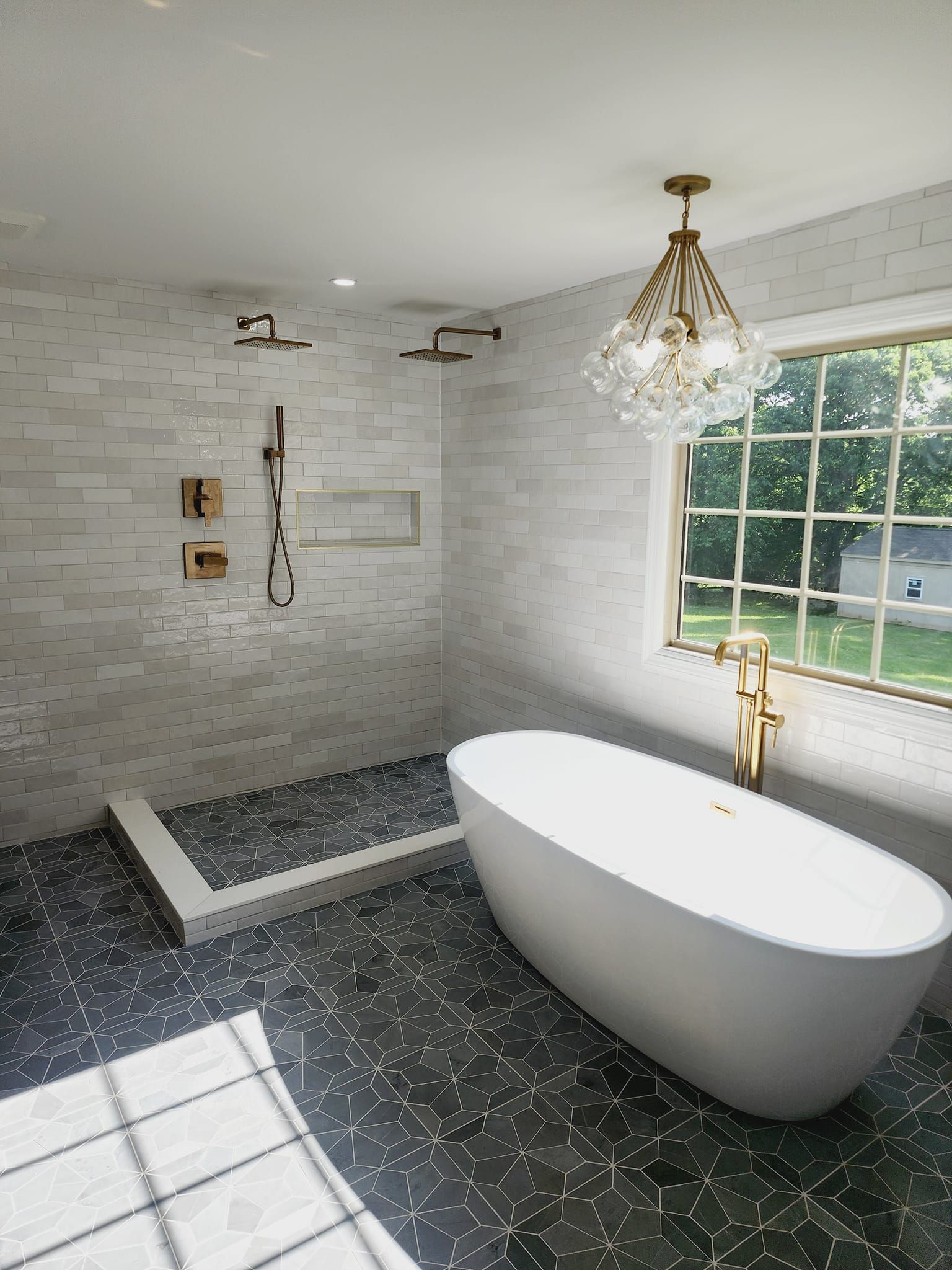 A bathroom with a bathtub, shower, and window