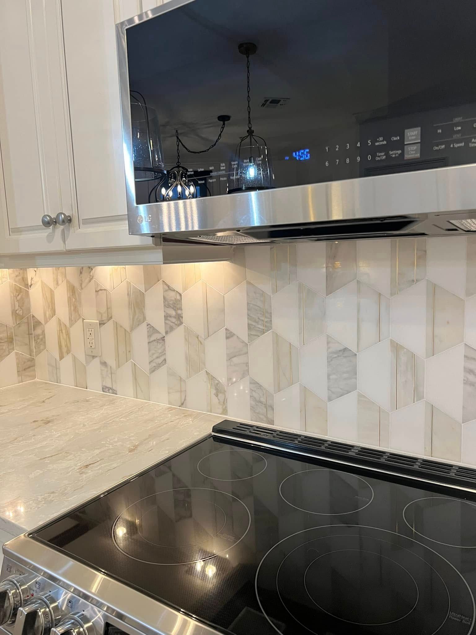 A kitchen with a stove top oven and a microwave