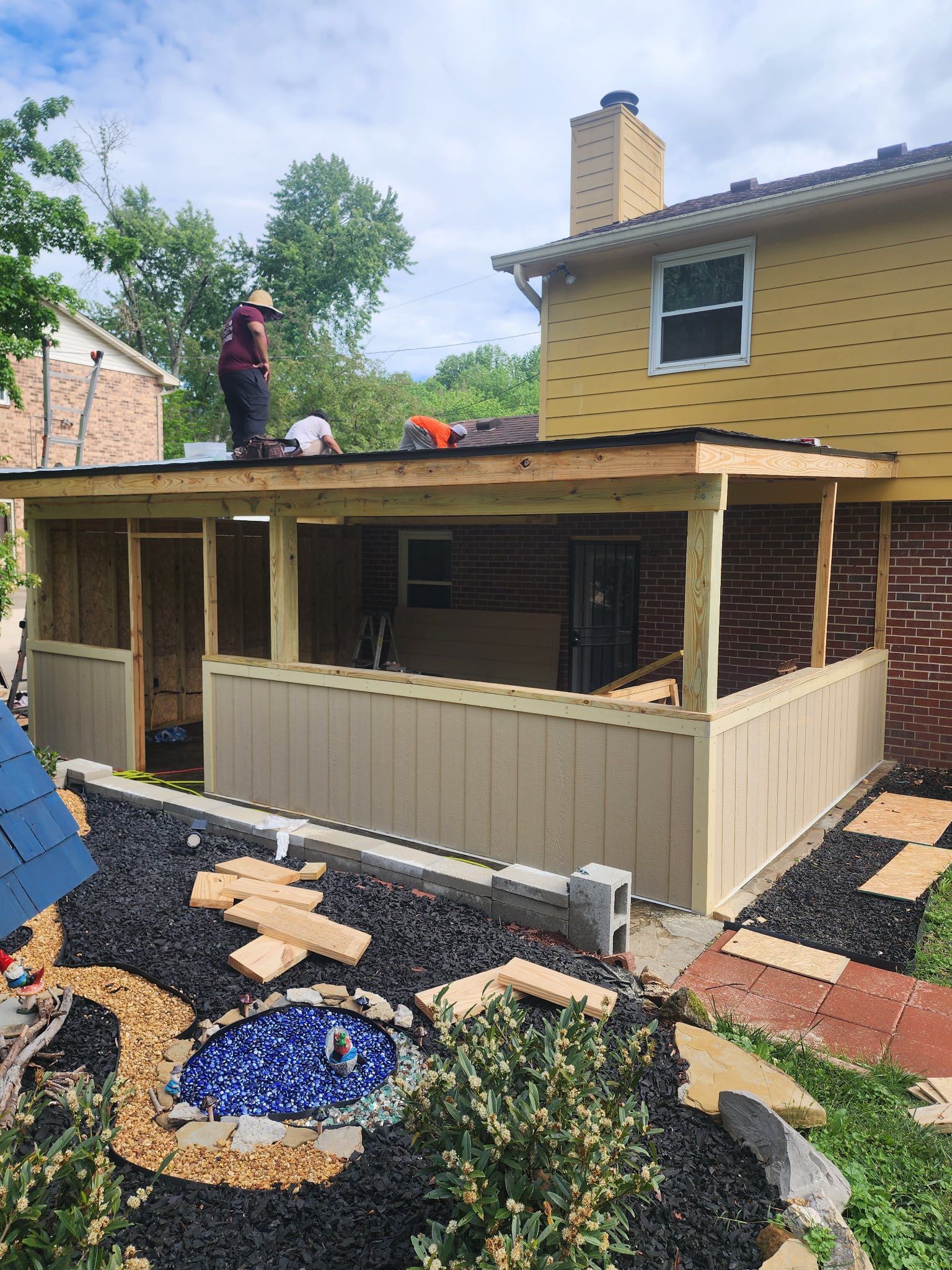 A man is standing on the roof of a house