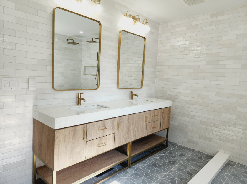 A bathroom with two sinks and two mirrors