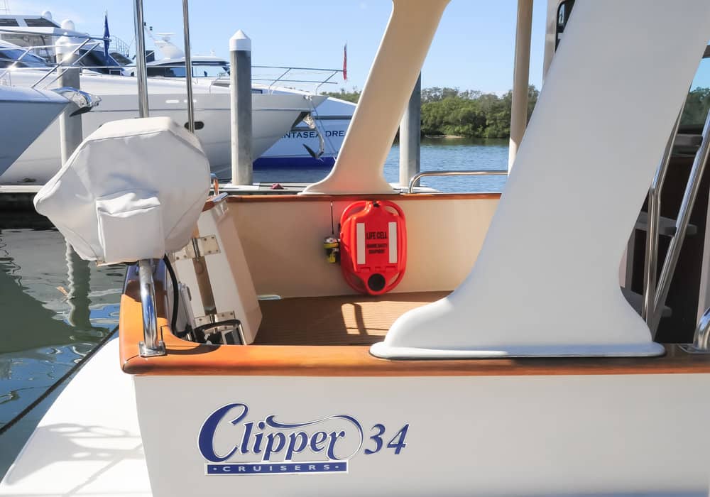 A white boat with the name clipper 34 on the side LIFECELL products