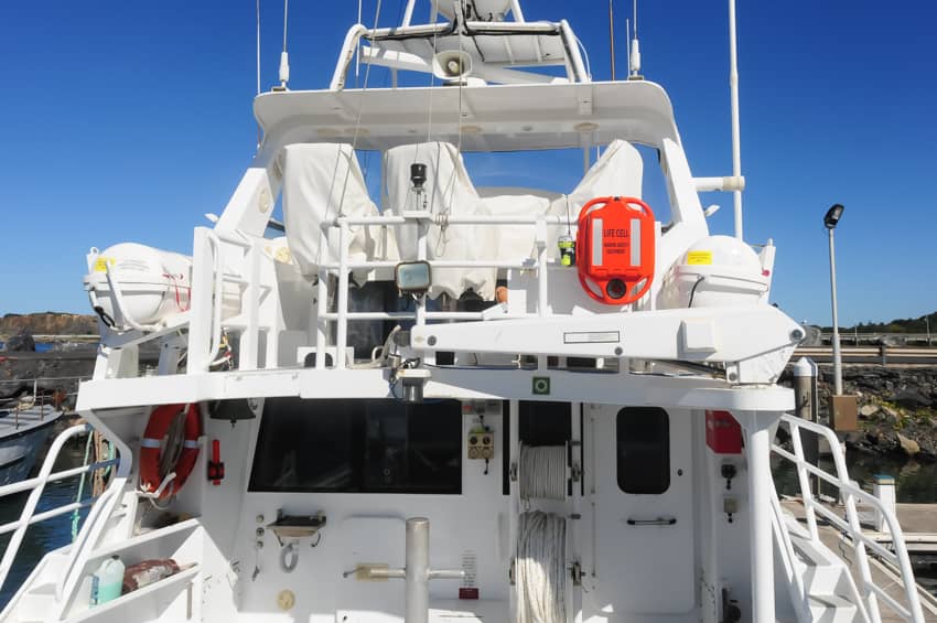 A large white boat is docked in a harbor. LIFECELL products