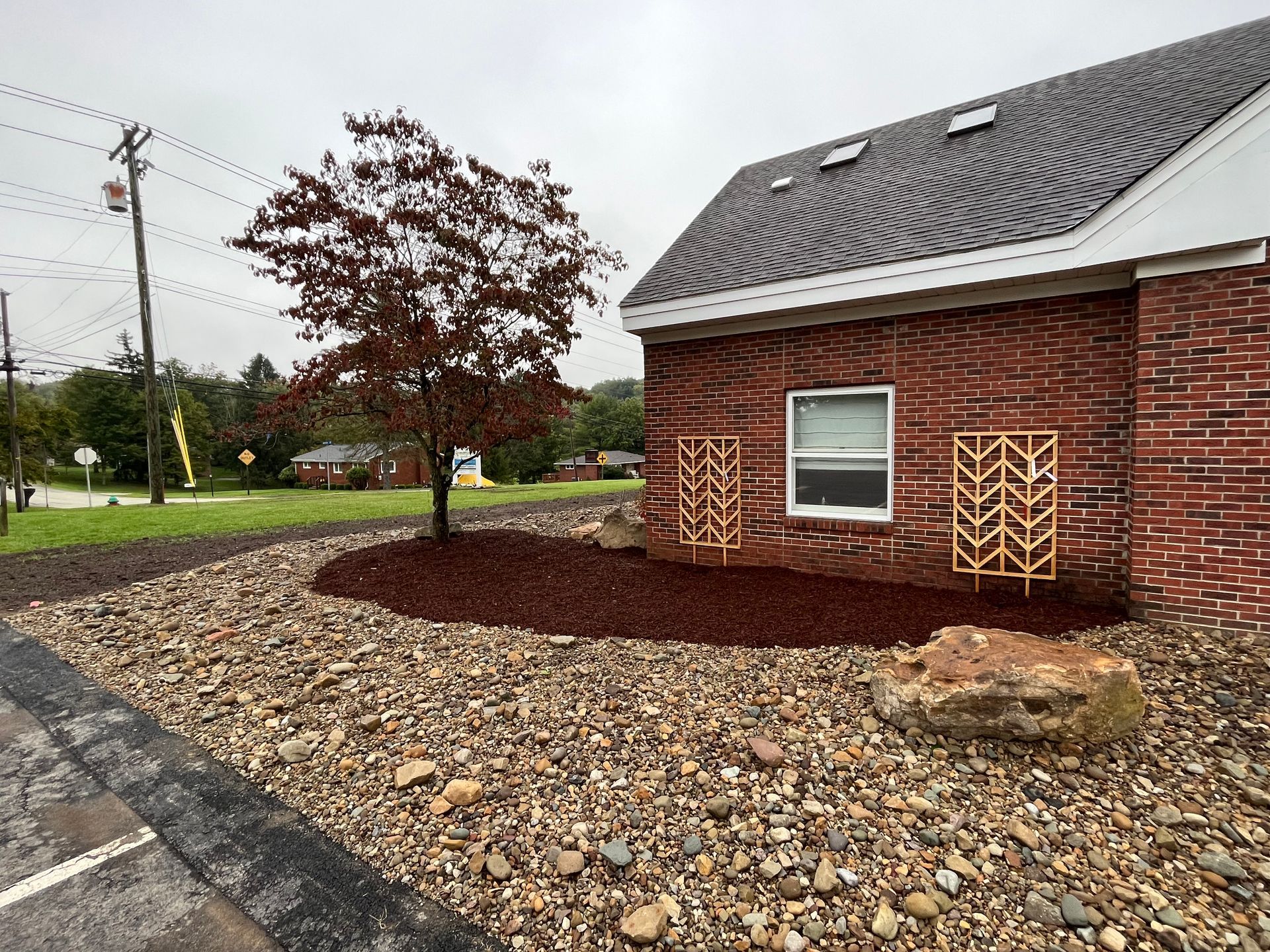 A brick building with a tree in front of it.
