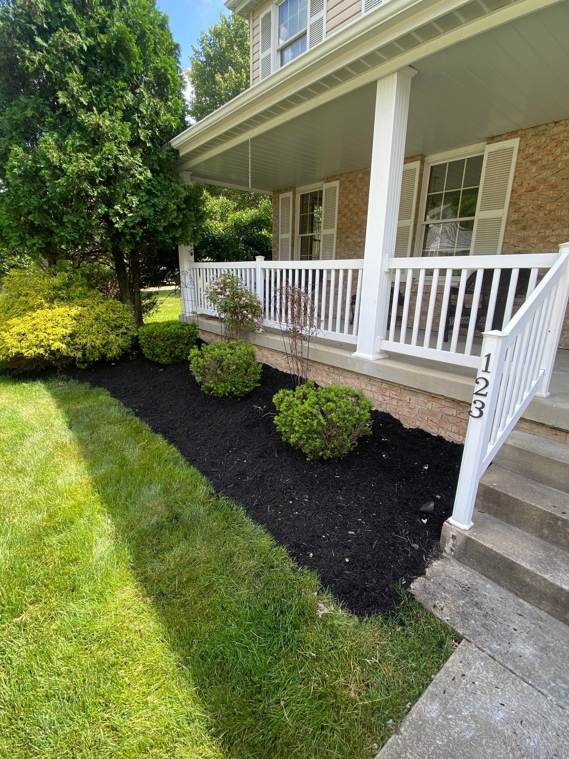 The front of a house with a porch and stairs.