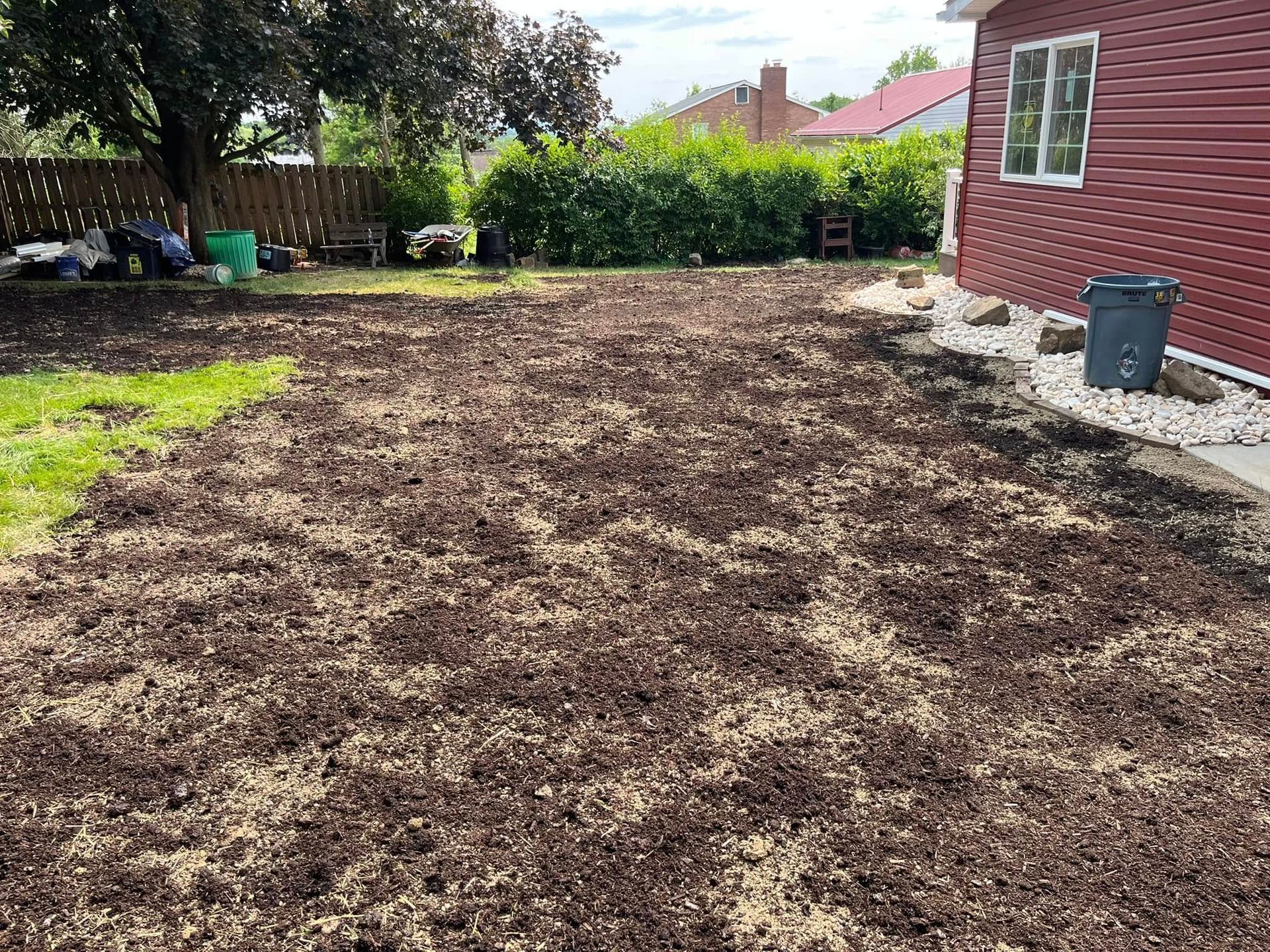 There is a lot of dirt in the backyard of a house.