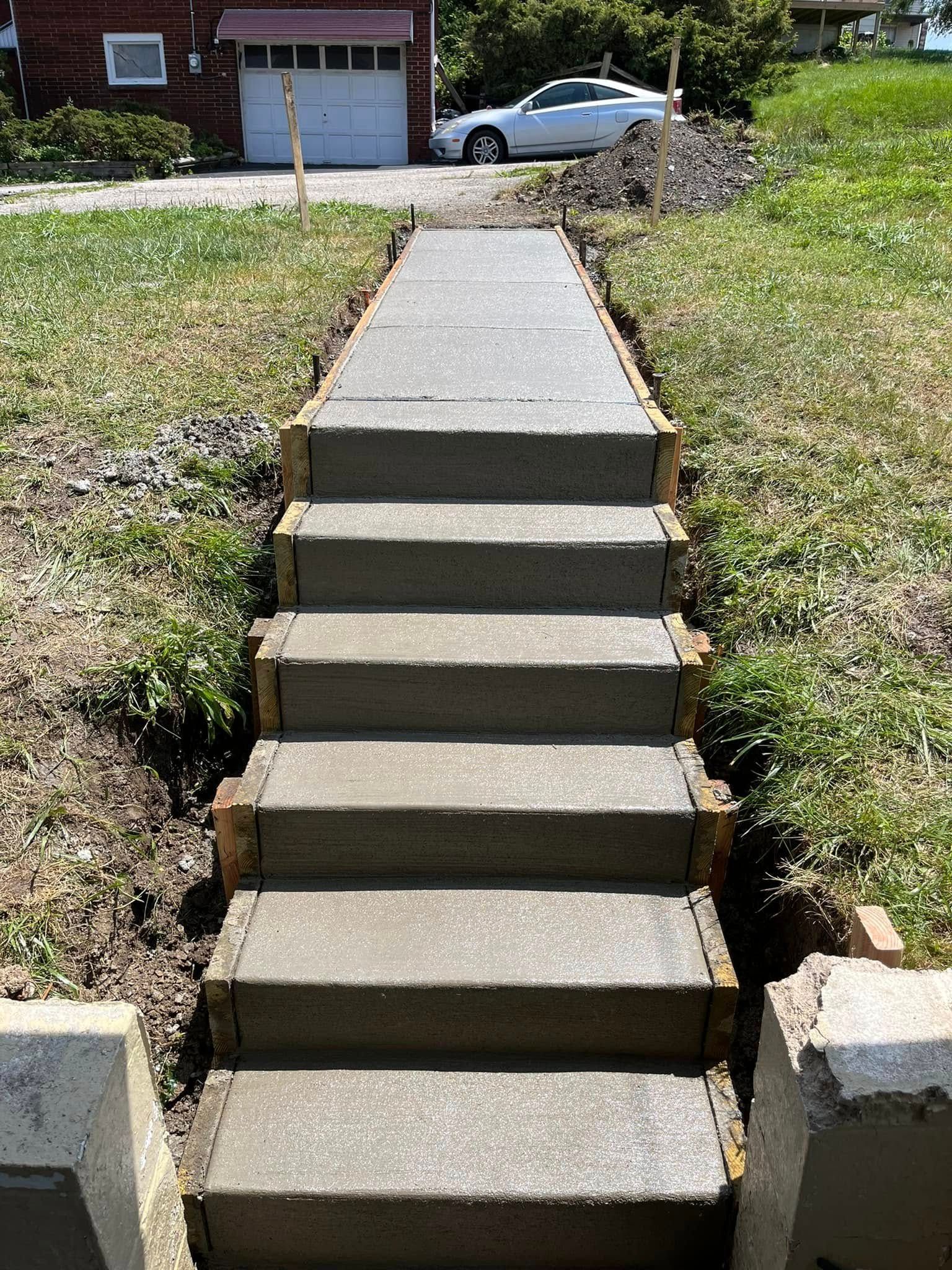 A set of concrete stairs leading up to a garage.
