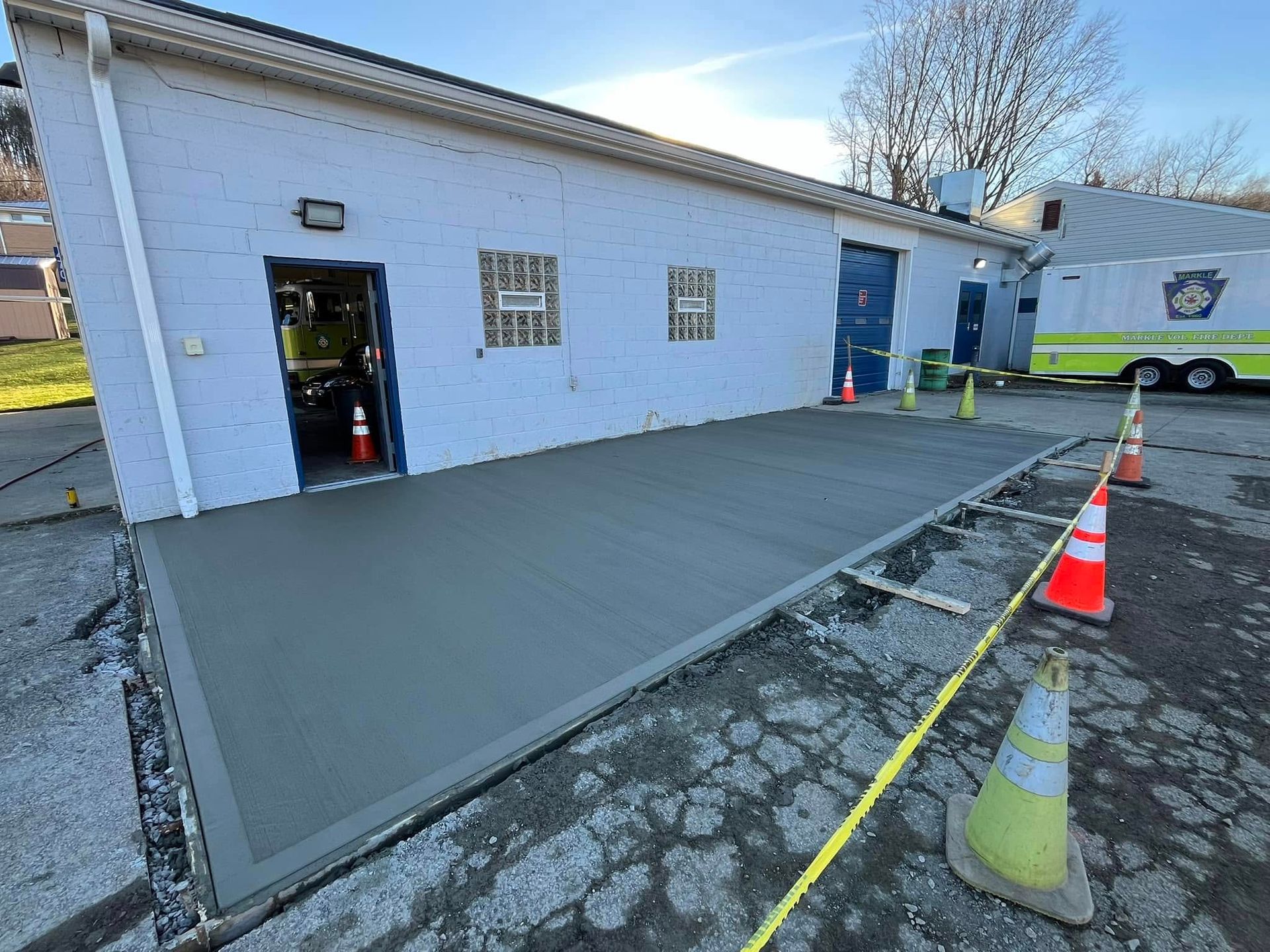 A concrete walkway is being built in front of a building.