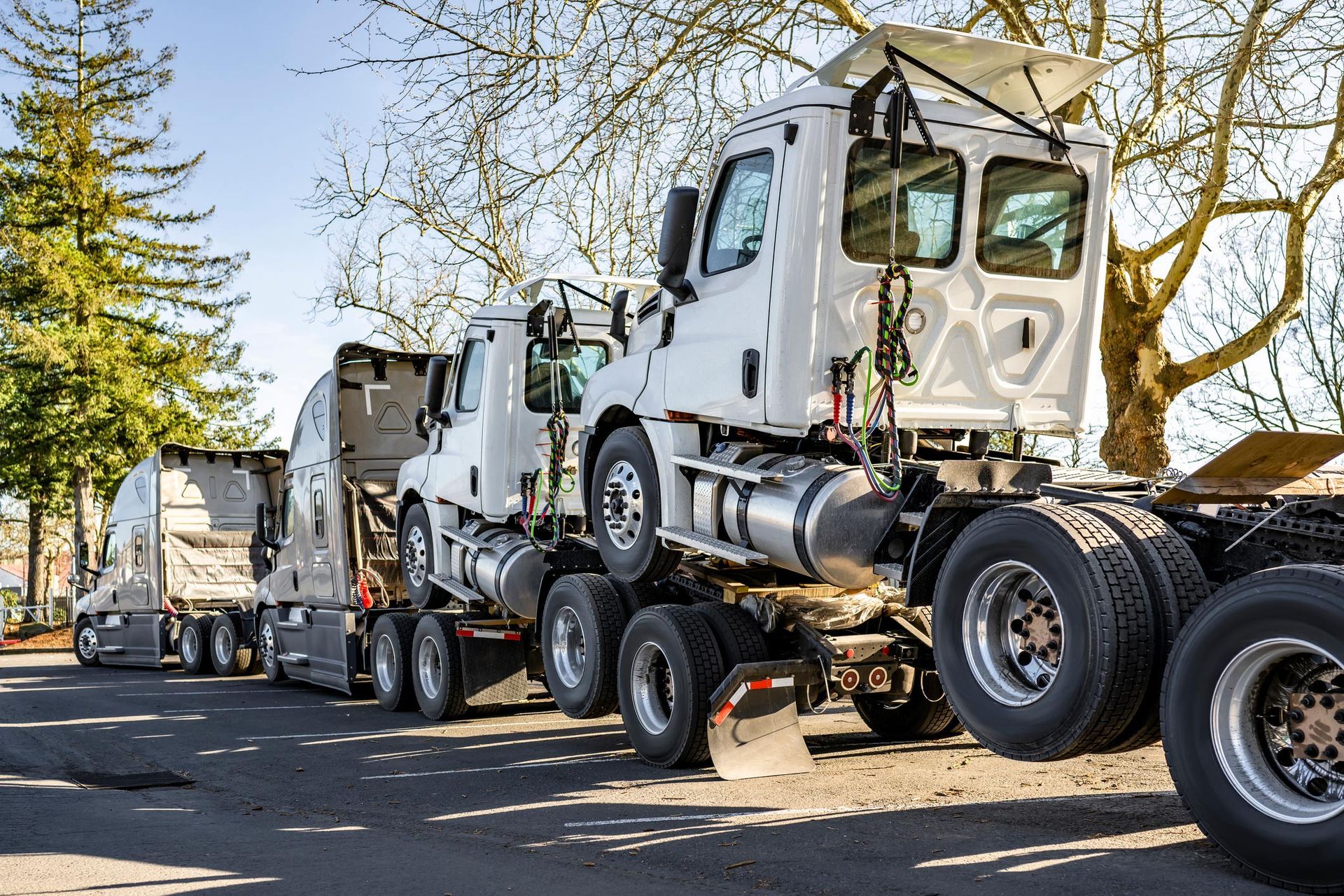 Semi-trucks carrying new truck cabs on a sunny day. Semi-trucks carrying new truck cabs on a sunny day.
