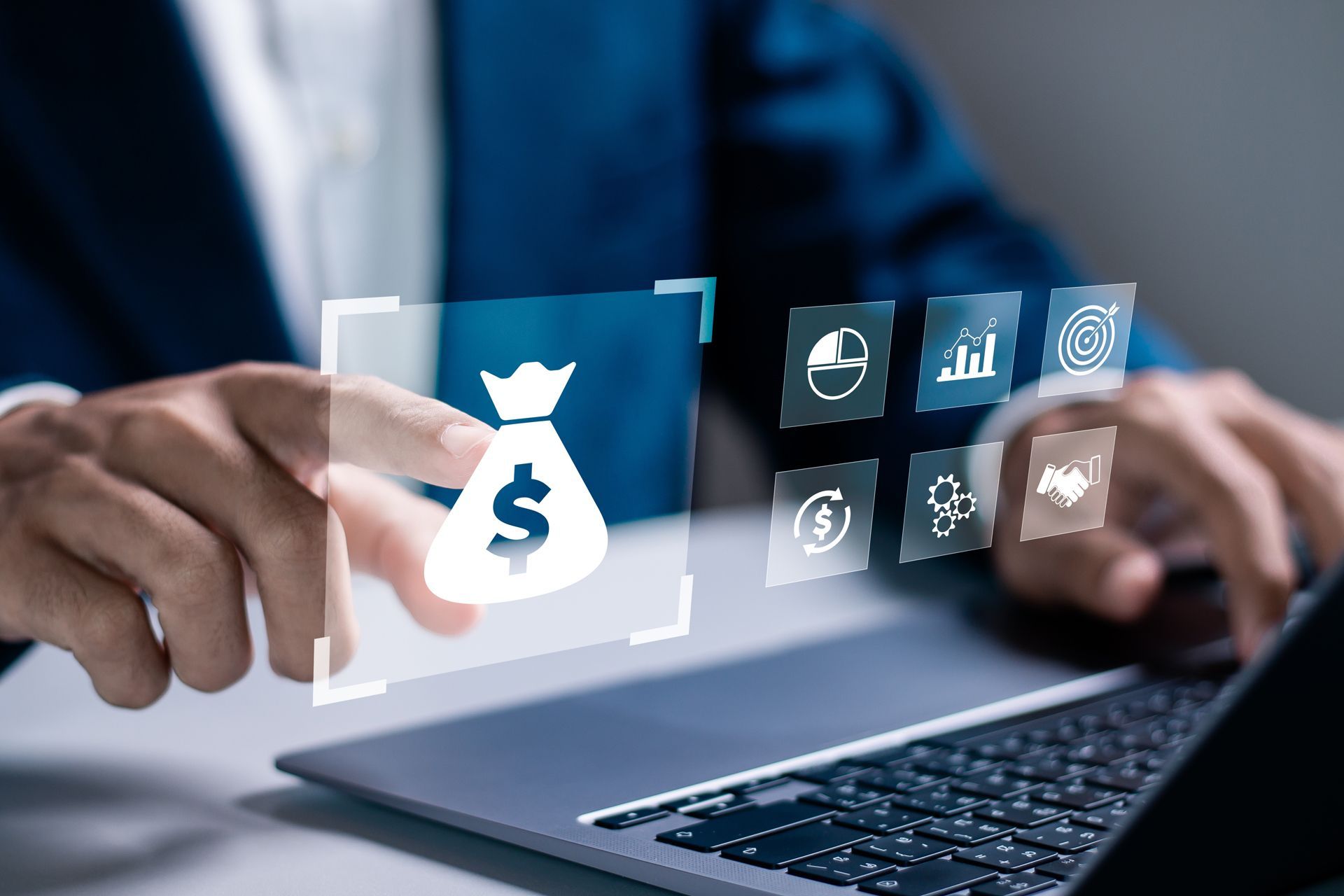 A Man is Using a Laptop Computer With a Bag of Money on the Screen