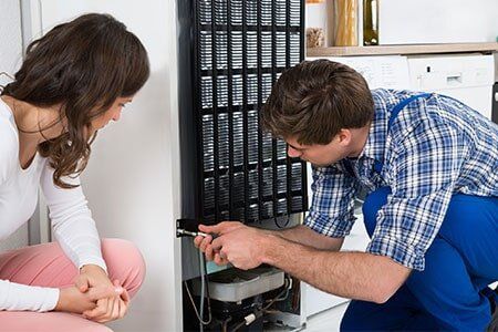 Repairman Repairing Refrigerator — Appliances in Gary, IN