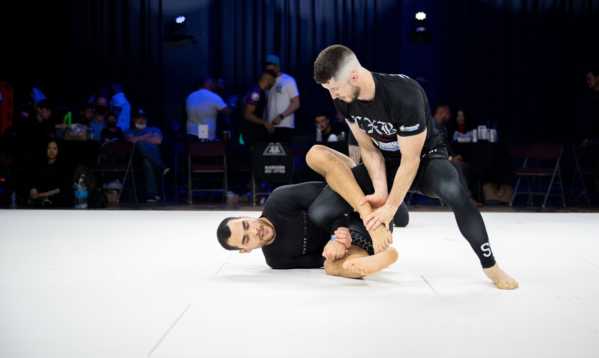 Students practice hip mobility drills at Breathe Jiu Jitsu in Yaphank, NY to improve guard movement.