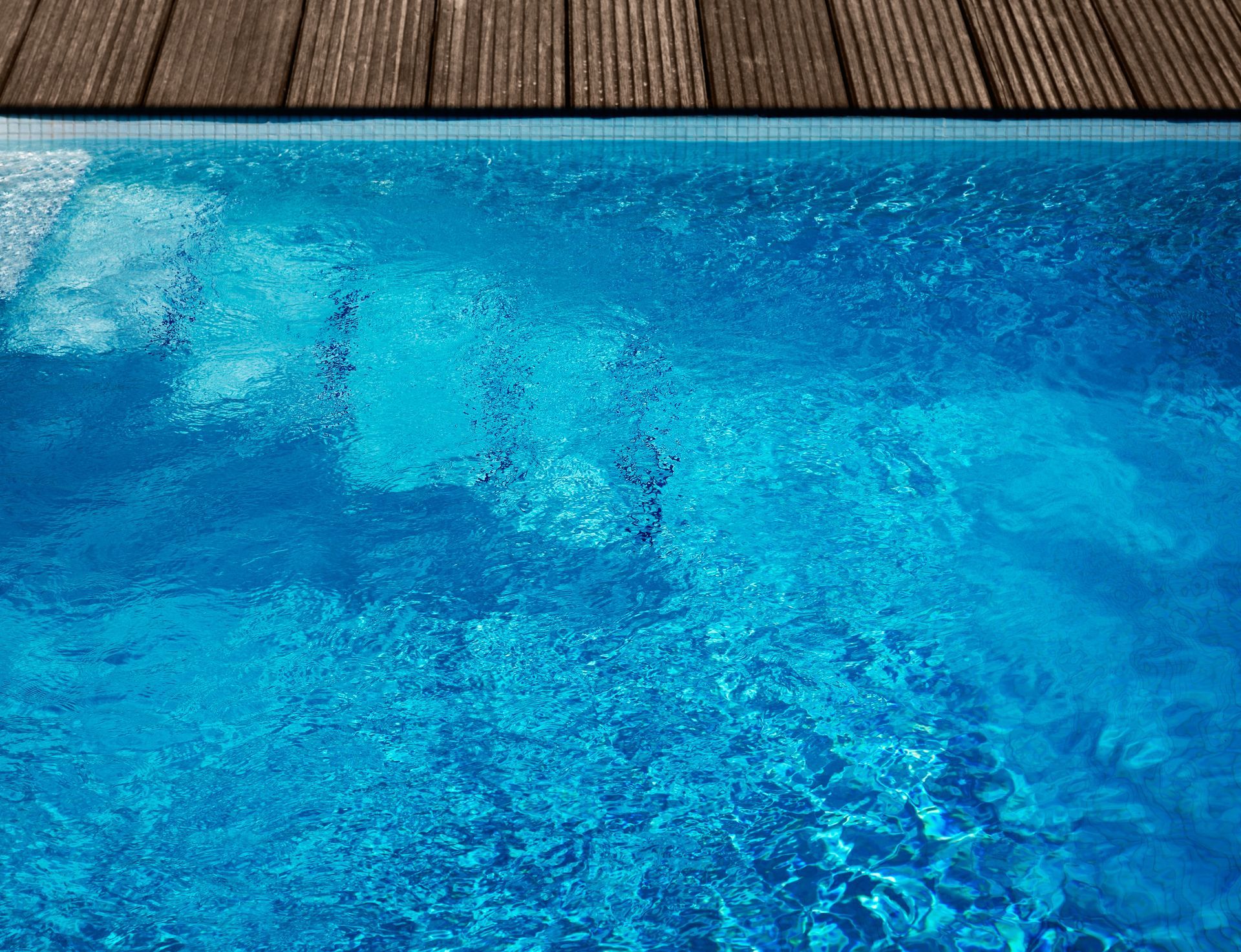 Clean blue swimming pool with net skimmer underwater.