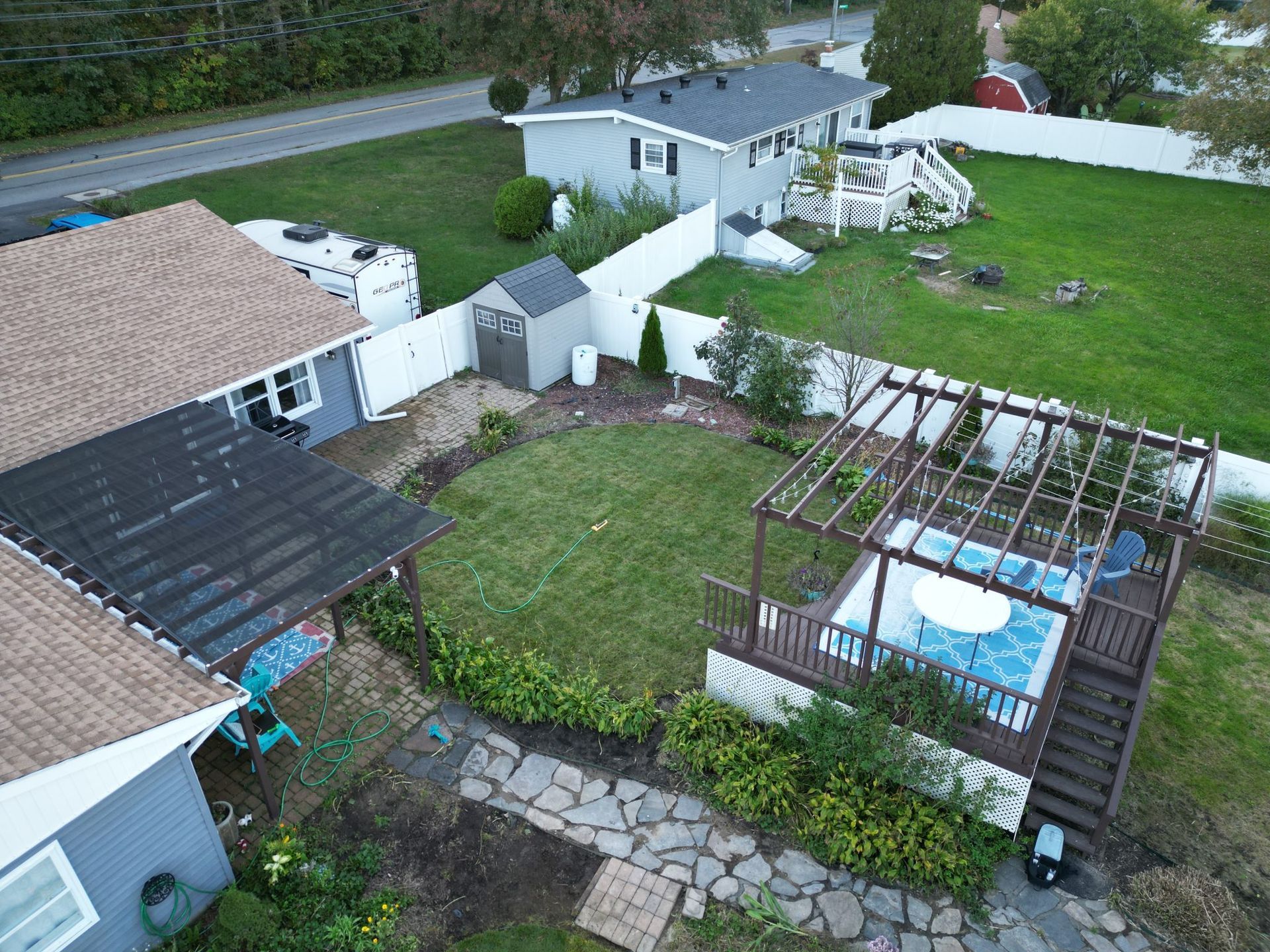 An aerial view of a house with a pool in the backyard.