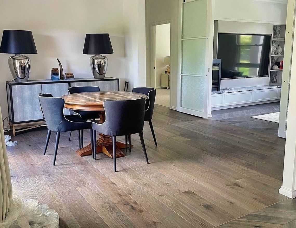 A Dining Room with A Table and Chairs and Lamps — Tony Di Milia Flooring in Unanderra, NSW