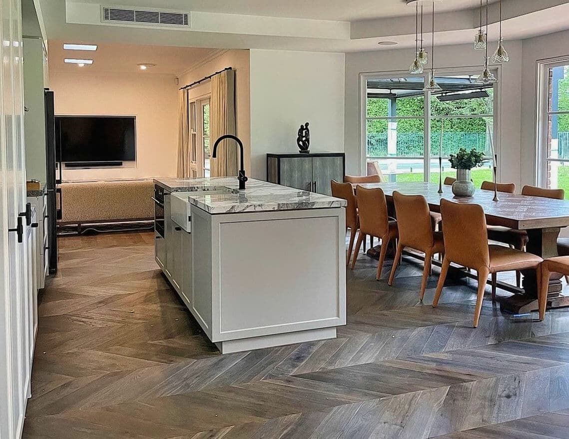 A Kitchen and Dining Room in A House with A Large Island in The Middle — Tony Di Milia Flooring in Unanderra, NSW