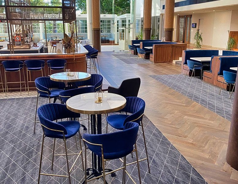 A Restaurant with Tables and Chairs and A Bar — Tony Di Milia Flooring in Unanderra, NSW