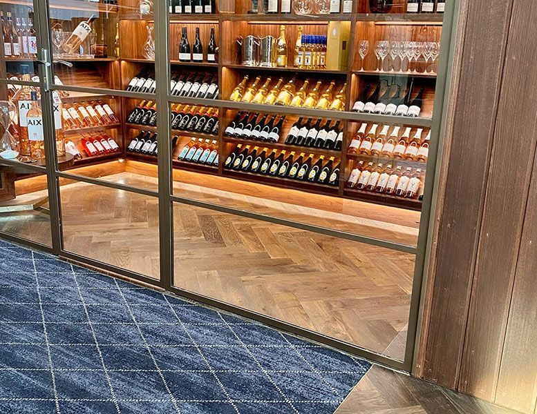 A Wine Cellar Filled with Lots of Wine Bottles and Glasses — Tony Di Milia Flooring in Unanderra, NSW