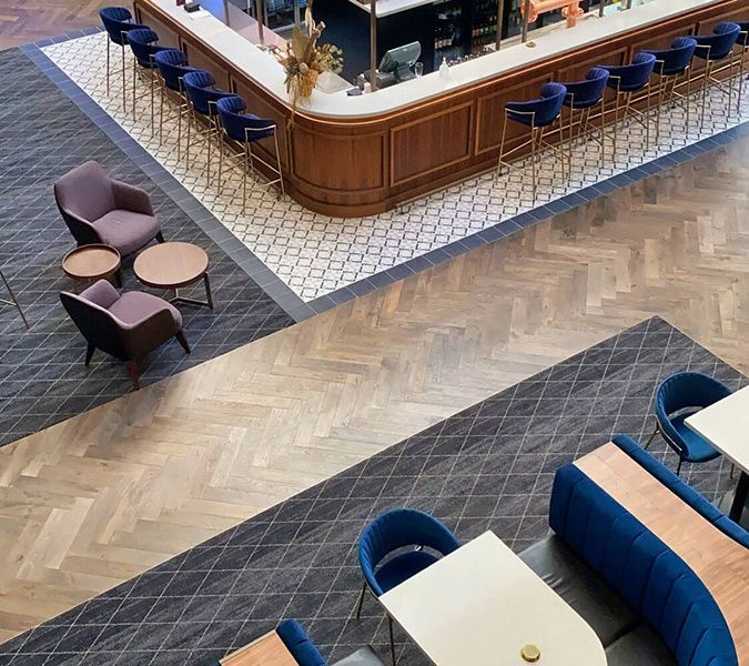 An Aerial View of A Restaurant with Tables and Chairs and A Bar — Tony Di Milia Flooring in Unanderra, NSW