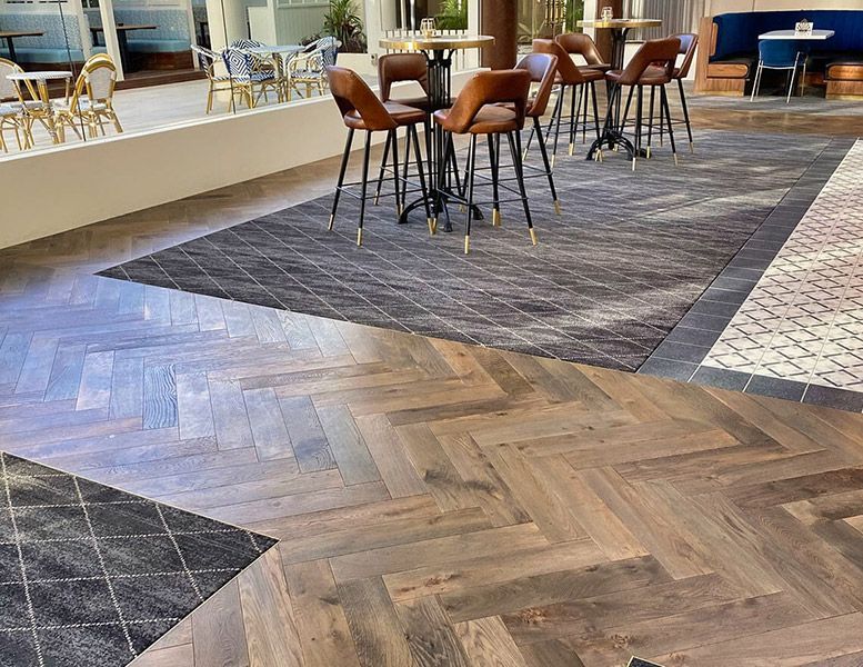 A Restaurant with Tables and Chairs on A Wooden Floor — Tony Di Milia Flooring in Unanderra, NSW